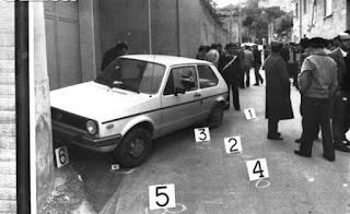 Onlookers gather round Ciaccio Montalto's car the day after the magistrate was killed
