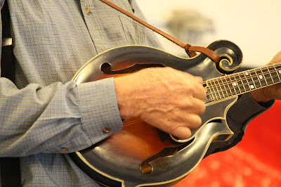 mandolin being played by gray shirt player