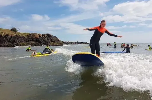 Kids learn surfing at brittas bay beach