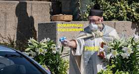 masked priest with water pistol