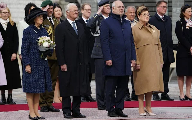 Queen Silvia wore a navy tweed coat, tweed jacket and navy tweed dress by Chanel. Mrs Sirje Karis and Prime Minister Kaja Kallas
