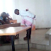 Ivorien professor pictured backing a student's baby