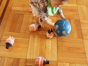 boy playing with DIY sumo wrestler bowling pins