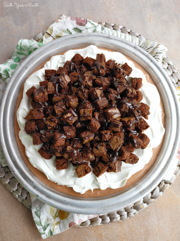 Triple Chocolate Brownie Cream Pie! Cream cheese, pudding mix, marshmallow crème and cool whip make a mousse-like chocolate filling in this brownie-bottom super simple, but luxurious dessert recipe!