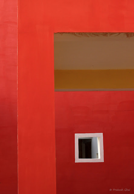 A Minimalist Photo of a White Square on a Red Wall