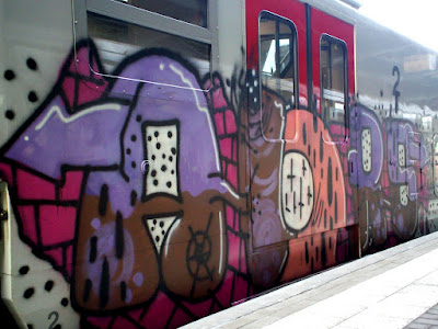 RAILROAD GRAFFITI A railcar in a dark rail yard provides a target for graffiti writers. Graffiti artists consider railcars the ultimate painting a traveling exhibition for talent and effort