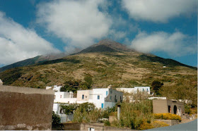 italian houses with mountain and cloudy sky above