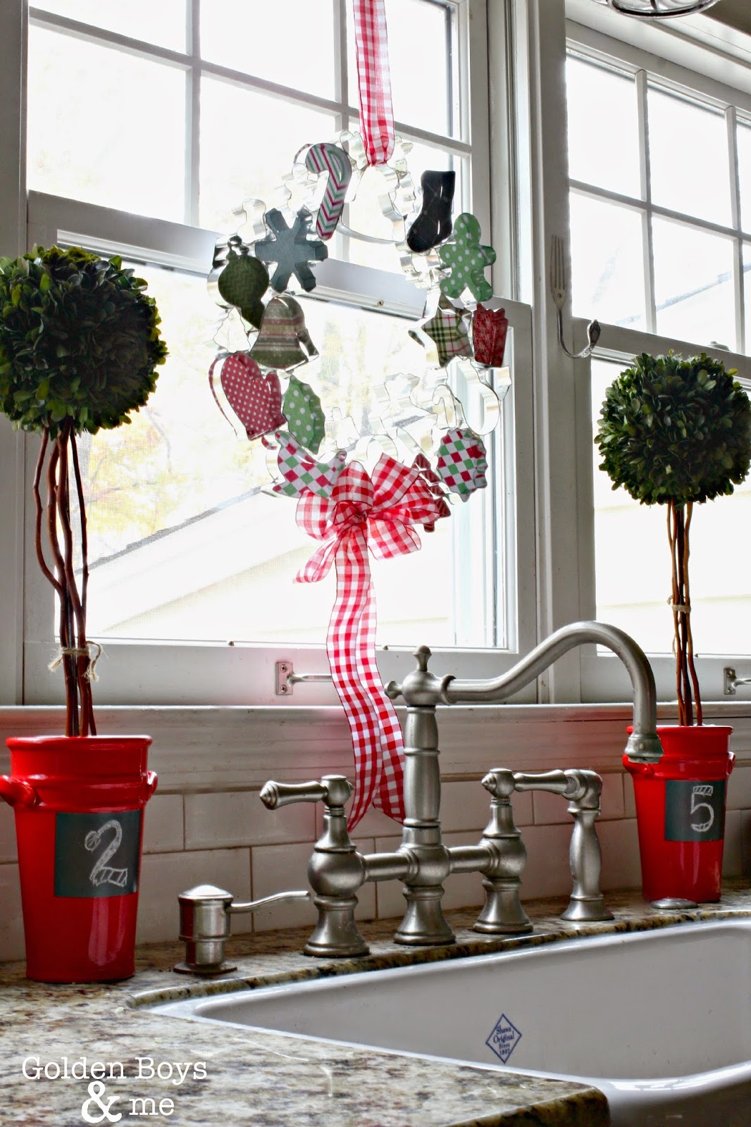 Cookie Cutter wreath over sink in Christmas decor with preserved boxwood topiaries-www.goldenboysandme.com