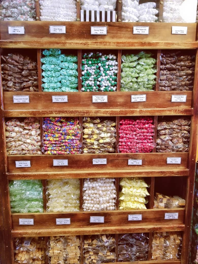 a picture of a shelf full of candies in various flavors and sizes