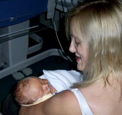 madmumof7 in hospital chair holding baby
