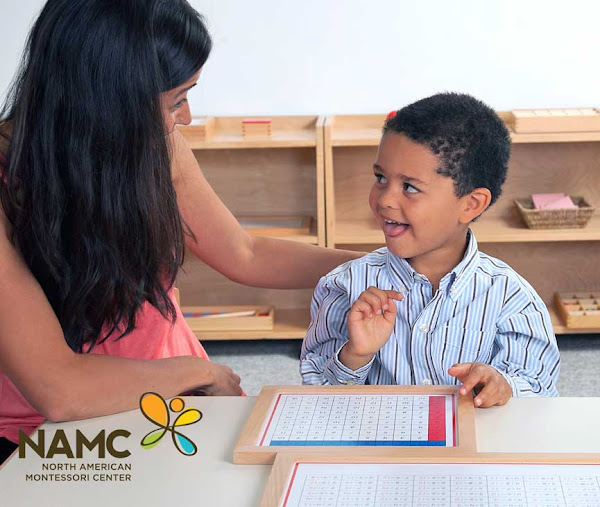 Montessori teacher and student working with Addition Chart. © NAMC