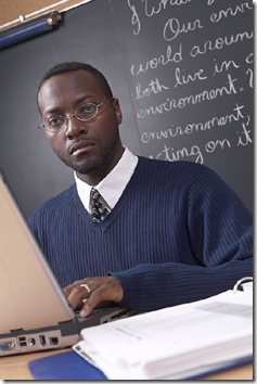 teacher_at_computer_and_blackboard