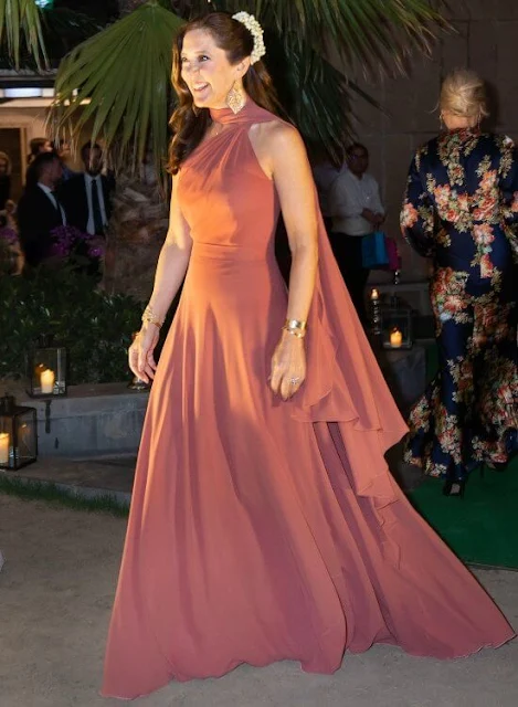 Crown Princess Mary wore a pink bespoke gown by Danish fashion designer Soeren le Schmidt. Brora gold charm earrings