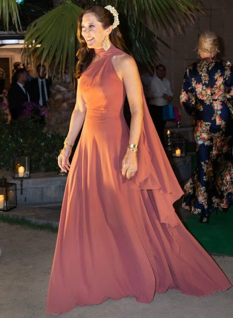 Crown Princess Mary wore a pink bespoke gown by Danish fashion designer Soeren le Schmidt. Brora gold charm earrings