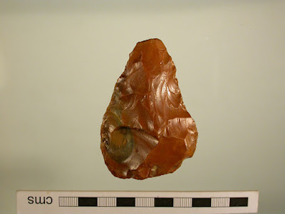 Lower Paleolithic handaxe of small size, possibly a reuse of the tip of a broken larger axe. 400,000 -300,00 BP