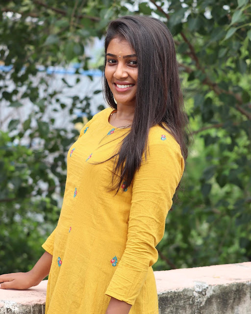 Tamil actress Kirthu in a mesmerizing yellow dress, radiating elegance and beauty.