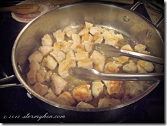 floured chicken cubes in pan