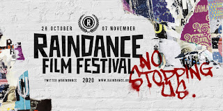 Raindance Film Festival written on a white brick wall surrounded by torn film posters and a graffiti'd "No Stopping Us"