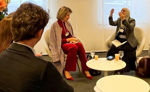 Queen Mathilde wore a red blouse by Dries Van Noten, Esmeralda Ammoun and Natan coat. Giorgio Armani black suit