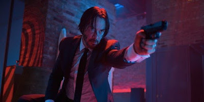 Movie scene- John Wick holding a gun