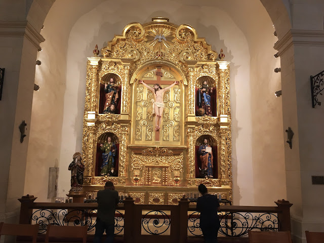 visitors praying at the altar at San Fernando Cathedral