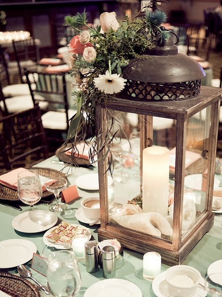 You could alternate lanterns with floral centerpieces