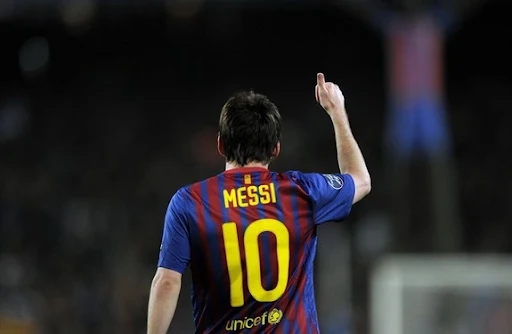 Barcelona forward Lionel Messi celebrates after scoring his second penalty against AC Milan