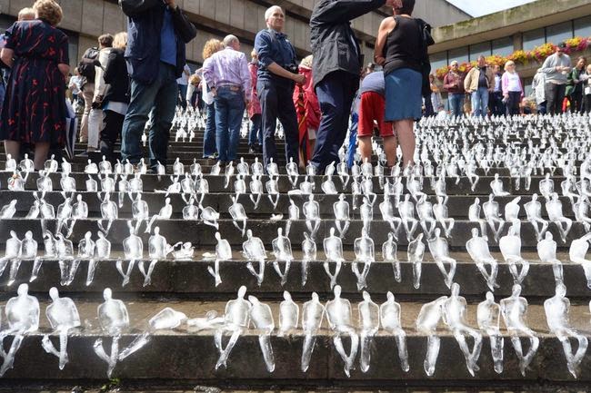 People took their turns placing the ice sculptures on the stairs. - To Commemorate WWI, This City Created A Powerful Temporary Ice Monument.