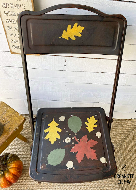 Photo of a fall leaf stenciled rusty chair.