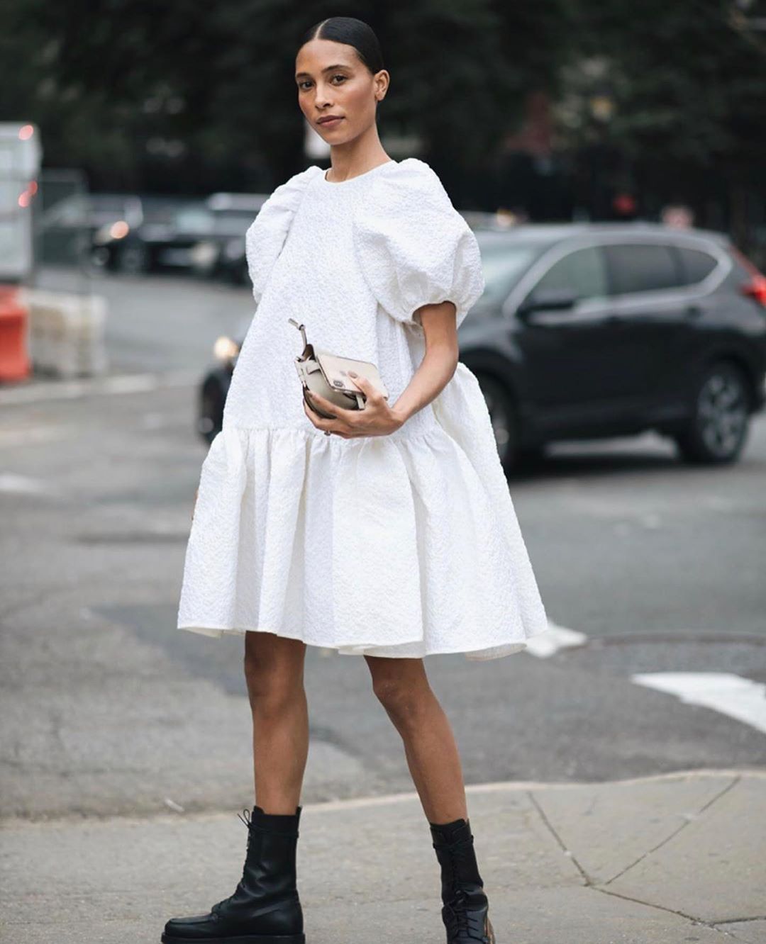 Tylynn Nyugen in a Cecilie Bahnsen puff-sleeve white dress with black combat boots
