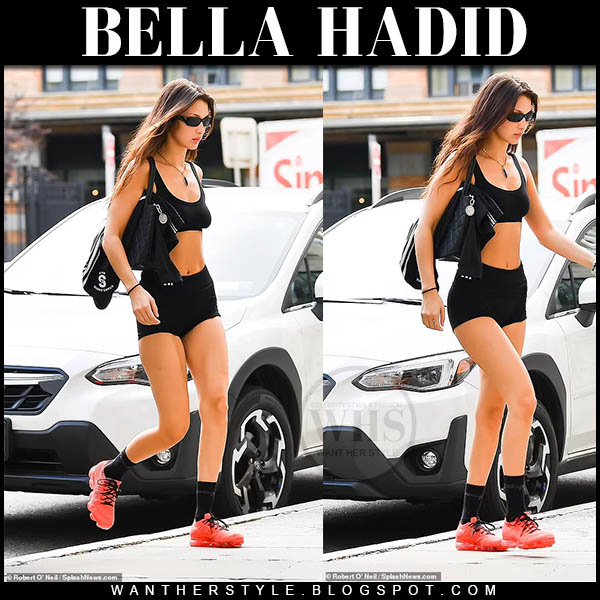 Bella Hadid in black sports bra, black shorts and red sneakers