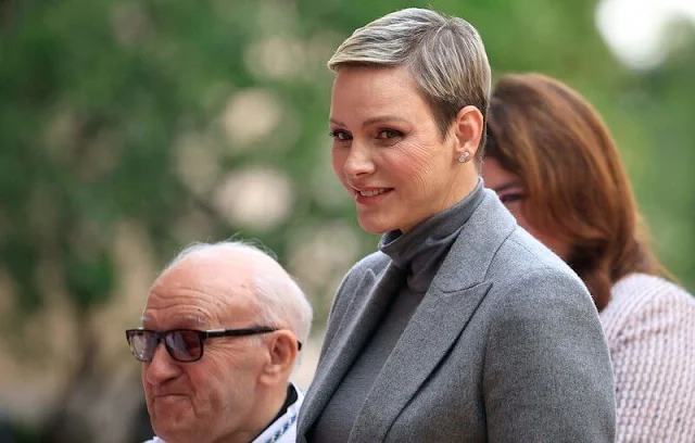 Prince Albert, Princess Charlene, Prince Jacques and Princess Gabriella. Charlene wore a grey jacket, sweater and skirt by Akris