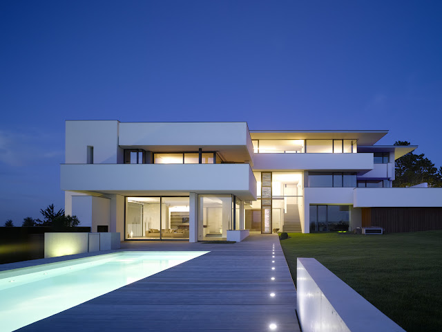 Photo of an amazing home at blue hour as seen from the pool area