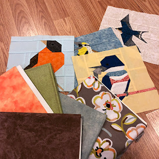 Pieced bird quilt blocks and fabric for a table topper