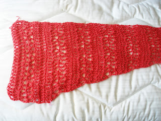 Coral colored lace shawl worked just past the center point