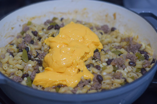 The Velveeta cheese sauce being added to the pot.