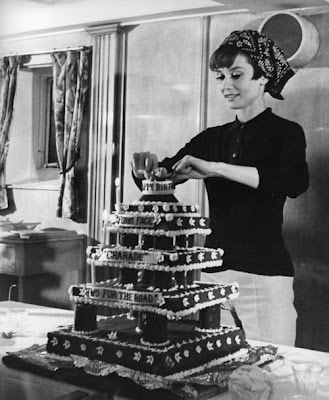 Audrey Hepburn decorating a cake for Stanley Donen