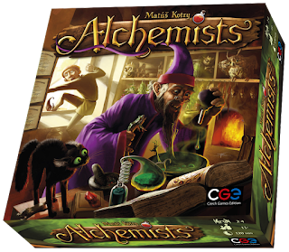 The Alchemists box, showing the cover art of a man in wizard's robes holding a frog in one hand as he adds drops of a strange liquid to a brew from which small hands can be seen reaching, as an apprentice climbs out a window in the background to escape the insanity of his master.