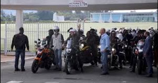 Brazil's President Jair Bolsonaro (center) leads a motorcycle rally , demonstrate his support for the far-right leader.