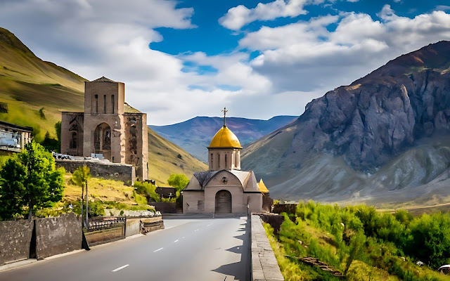 A scenic mountainous path guides visitors towards a tranquil monastery, harmoniously blending with the awe-inspiring landscape