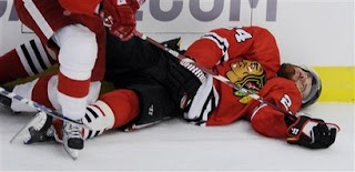 Chicago Blackhawks' Martin Havlat(notes) lays on the ice after being checked by Detroit Red Wings' Niklas Kronwall(notes) during the first period of Game 3 of the NHL hockey Western Conference finals in Chicago, Friday, May 22, 2009. The play drew a five-minute interference penalty and a game misconduct on Kronwall. Photo courtesy of AP