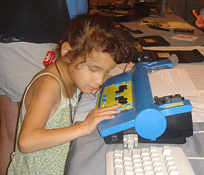 young girl using a Mountbatten Braille Writer