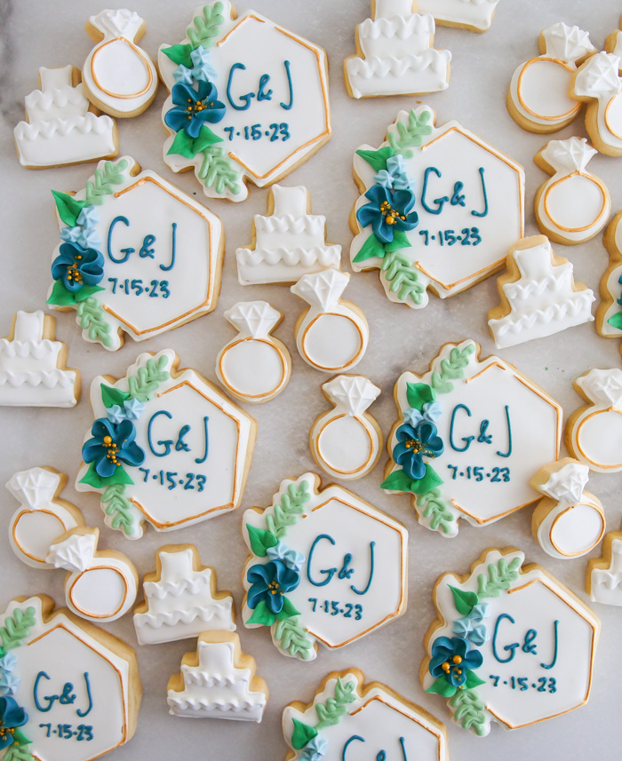 assorted decorated wedding cookies, large and mini in navy and gold theme