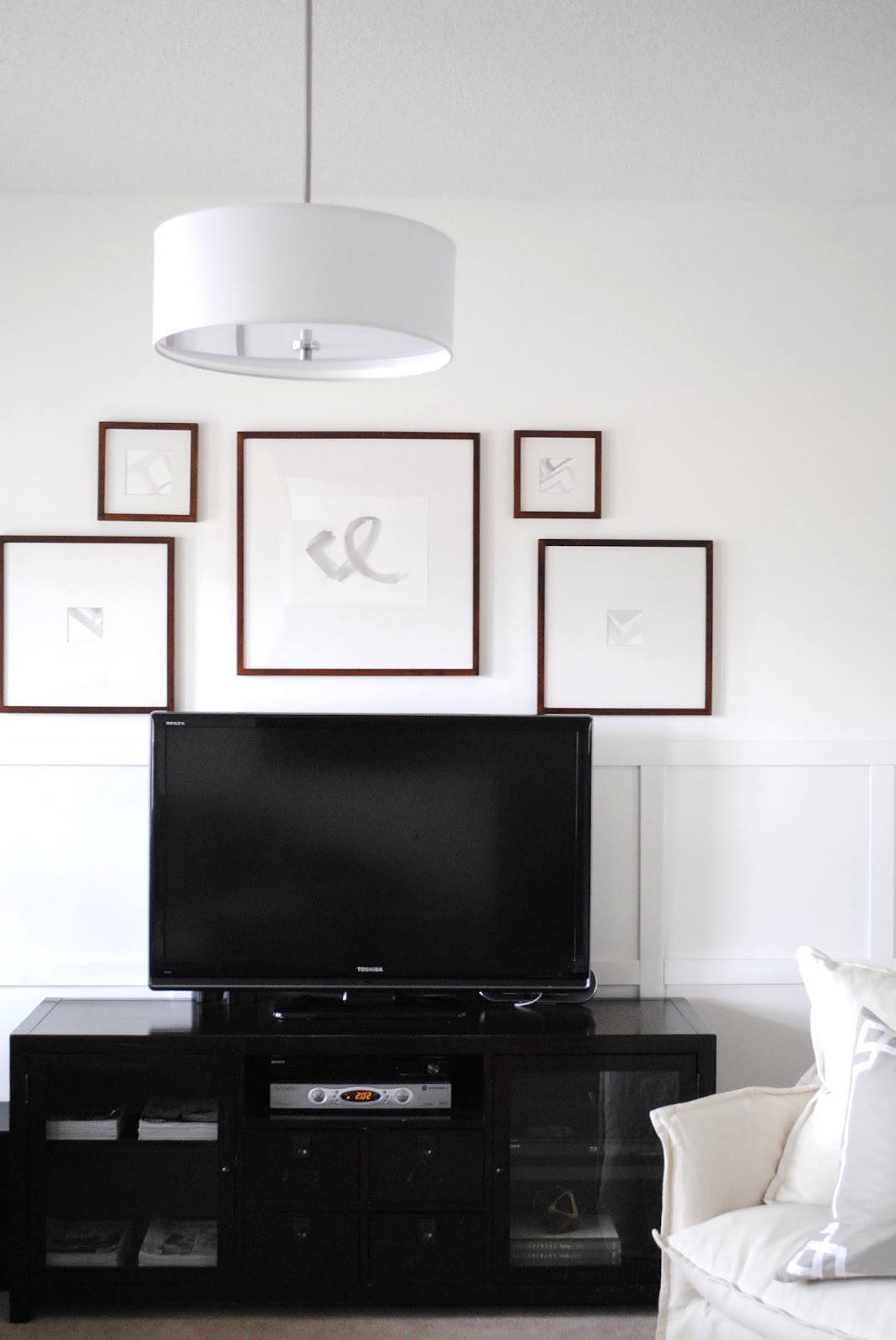 flourish design  style framing a TV  with a gallery wall 