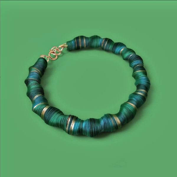 choker necklace composed of paper discs in green shades and metallic gold