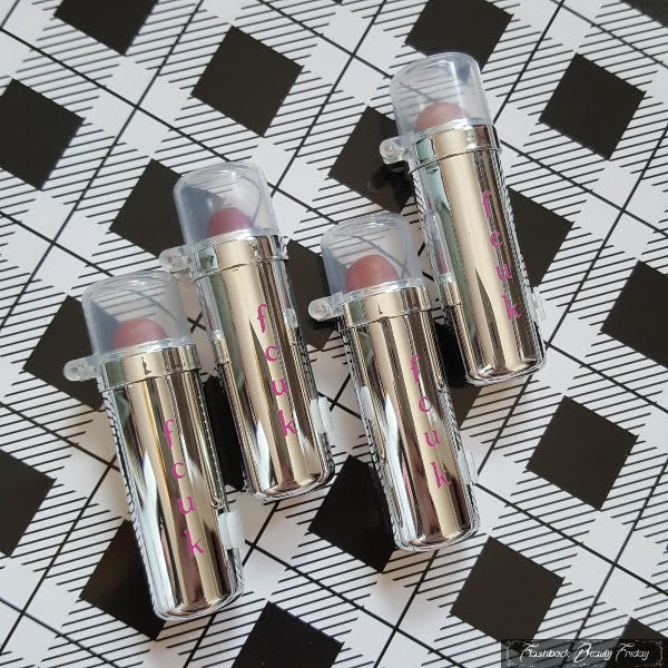 4 silver chrome lipstick cases in row with clear capped lids