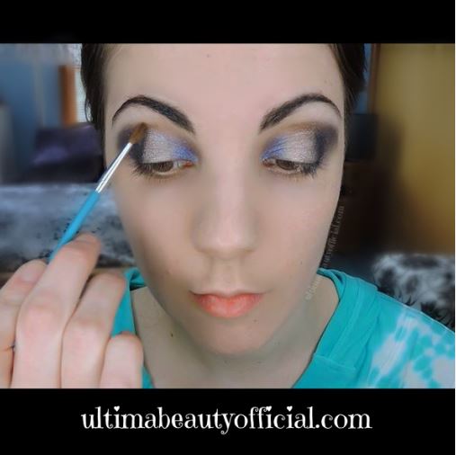 Ultima Beauty applying copper eyeshadow to the crease of the eye with a crease brush.