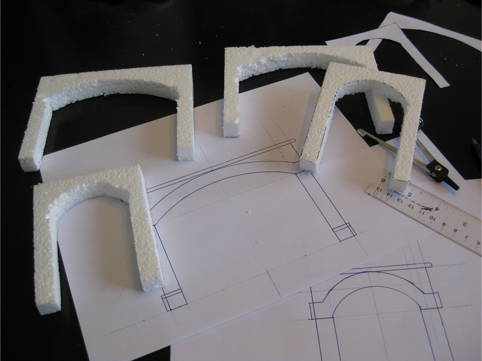 Tunnel portal templates and specifications drawn out on white copy paper with expanded foam mockups