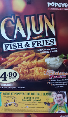 A poster for Popeyes (right side of poster cropped) for its Cajun fish and fries also refers to the 'football season'. 