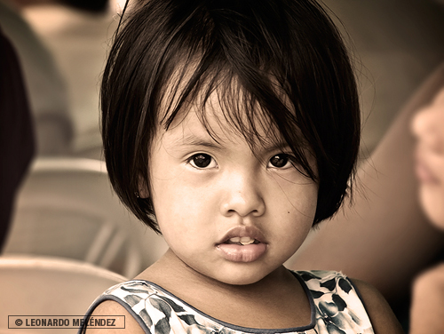 Belizean girl chewing chicle.